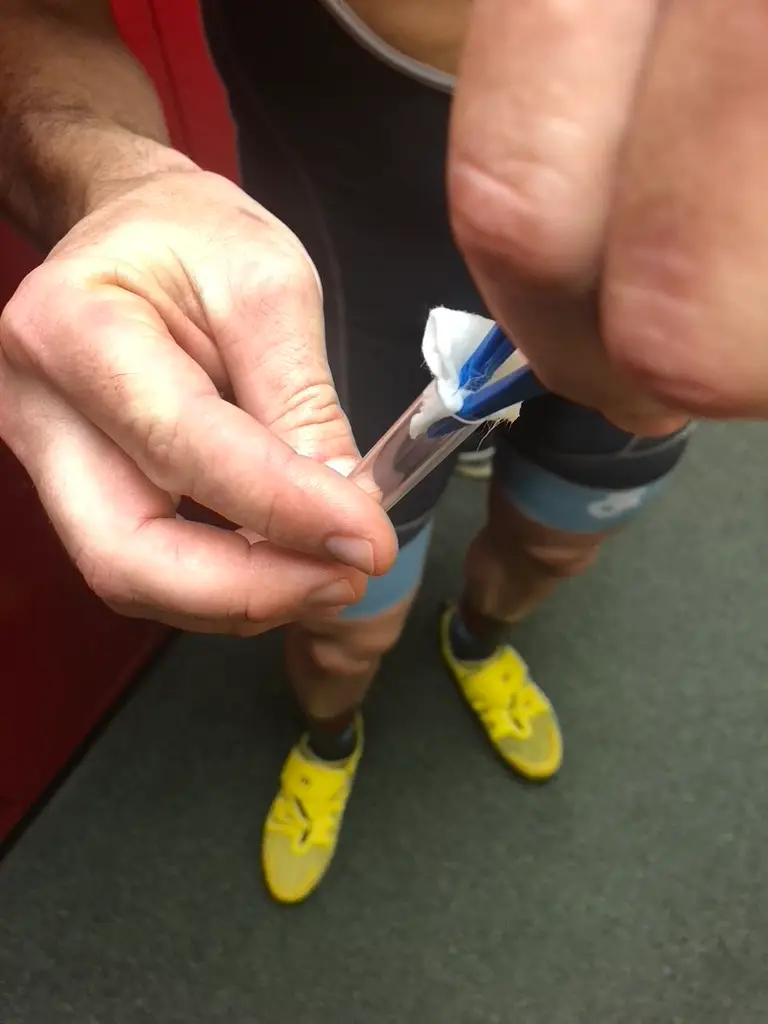Pad being placed into the sample collection tube using tweezers